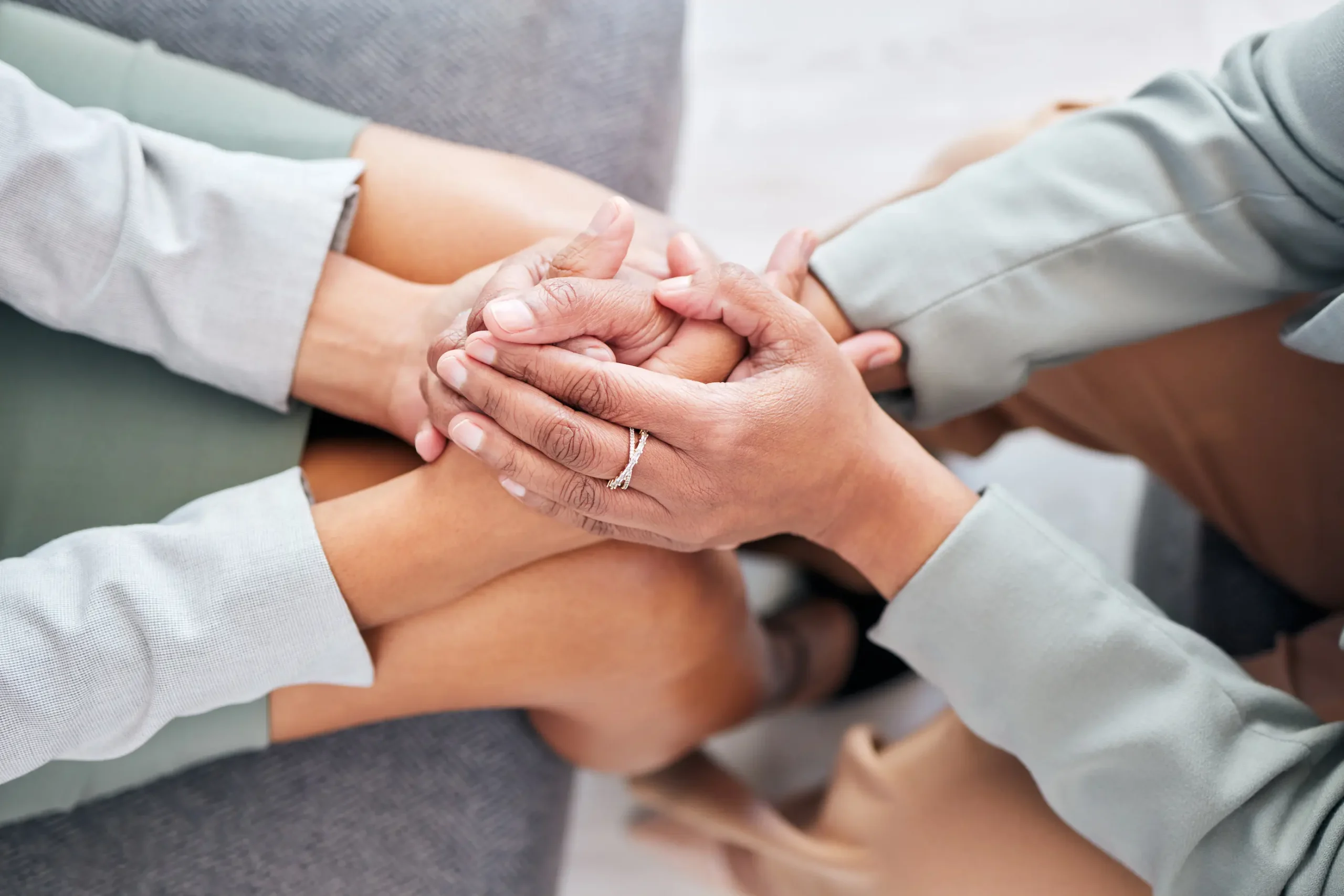 a close-up of hands holding each other