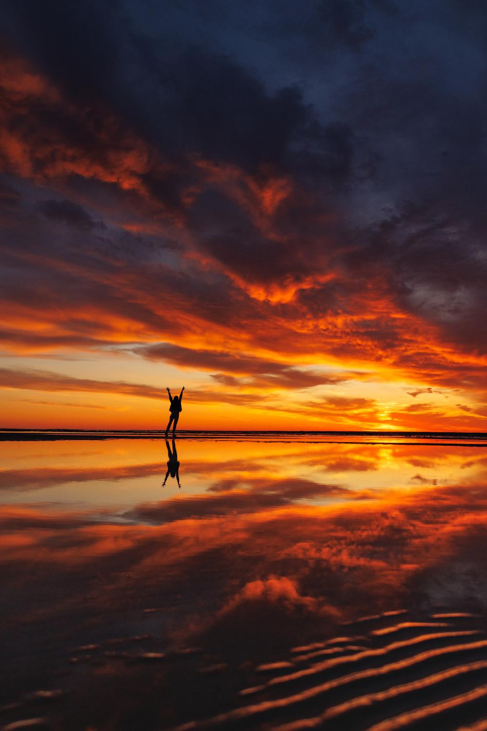 silhouette of person standing at beach at sunset - drug interventionist services for families in arizona