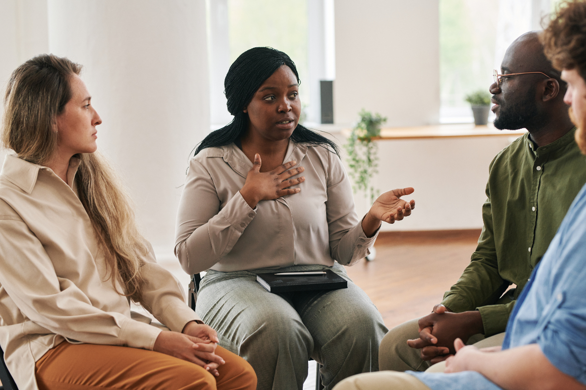 family sitting in room together having an intervention with a loved one - what is an intervention