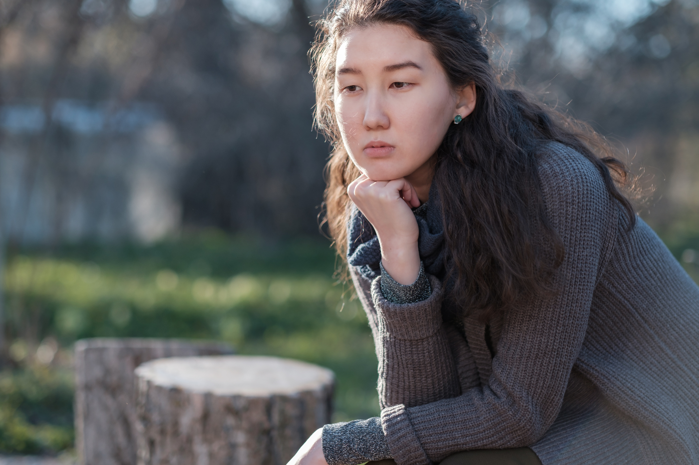 sad asian teen pondering life- hitting rock bottom from addiction