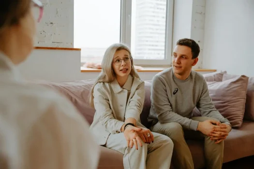 a man and woman sitting on a couch